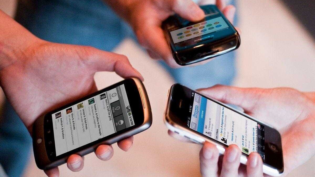 Три смартфона с разными интерфейсами на экранах