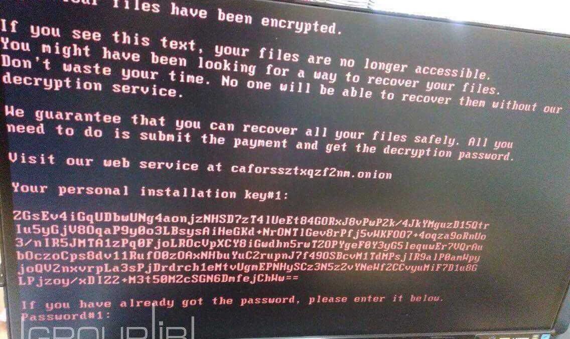 Экран компьютера с сообщением о шифровании файлов