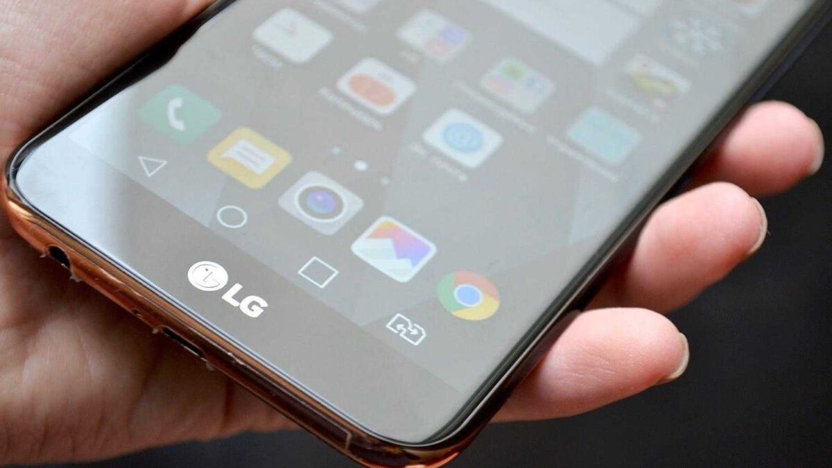 Смартфон LG K10 2018 в руке, передний экран и иконки приложений