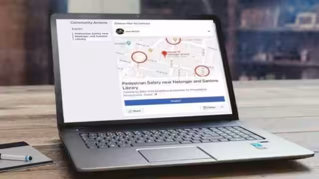 Ноутбук отображает страницу петиции на Facebook<a href=