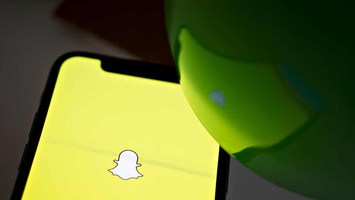 Смартфон с ярким желтым экраном и логотипом Snapchat
