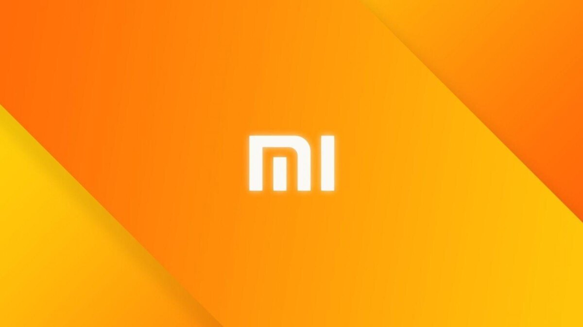 Фон с яркими оранжевыми и желтыми градиентами и логотипом Xiaomi Redmi K30