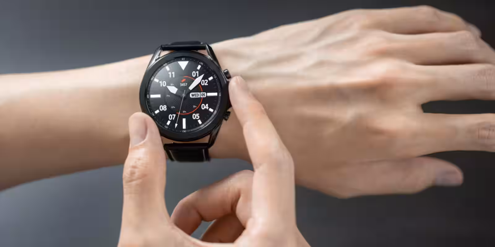 galaxy watch3 mystic black front hands on lifestyle scaled 1
