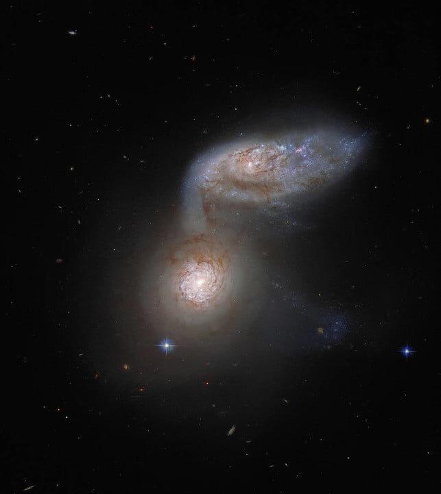 Two interacting galaxies that are so intertwined, they have a collective name – Arp 91. 