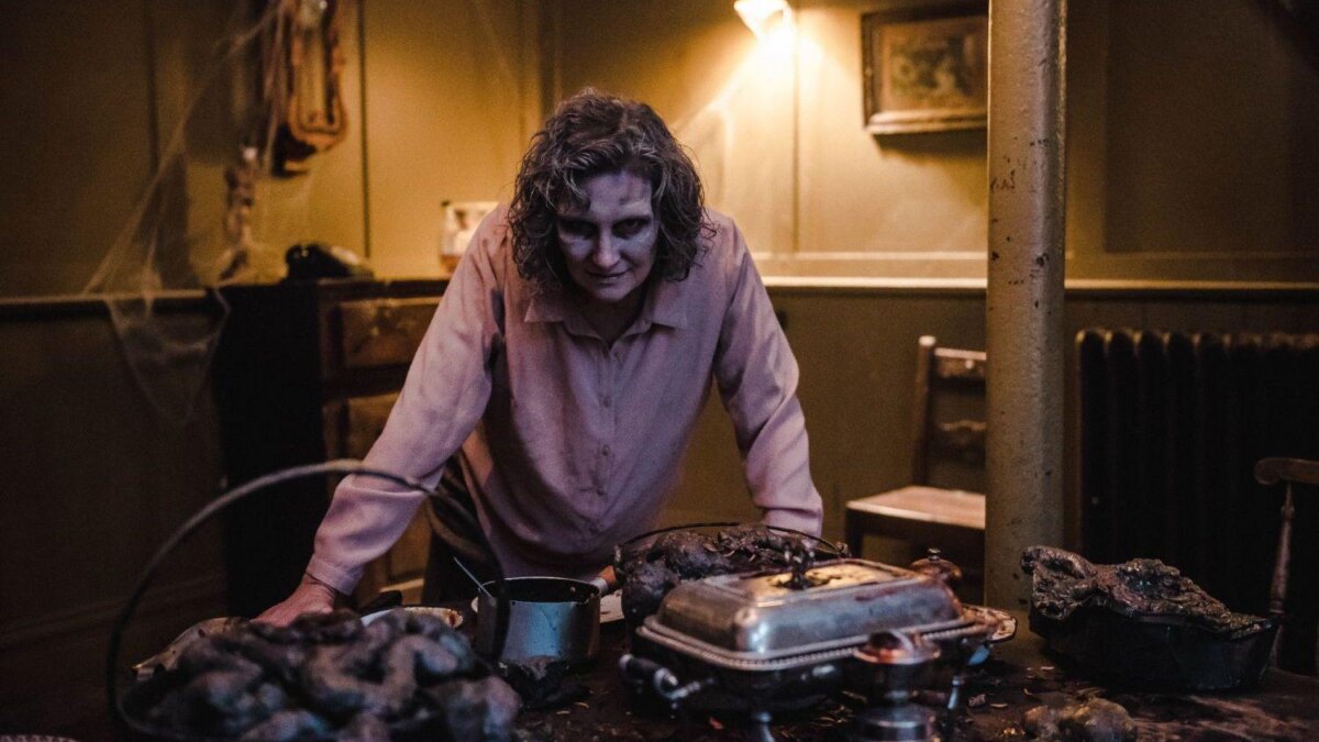 Женщина с растрепанными волосами за столом с жареной едой для PS5