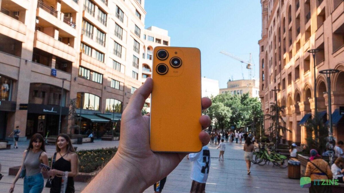 Обзор TECNO Spark 10 Magic Skin в руке на фоне города