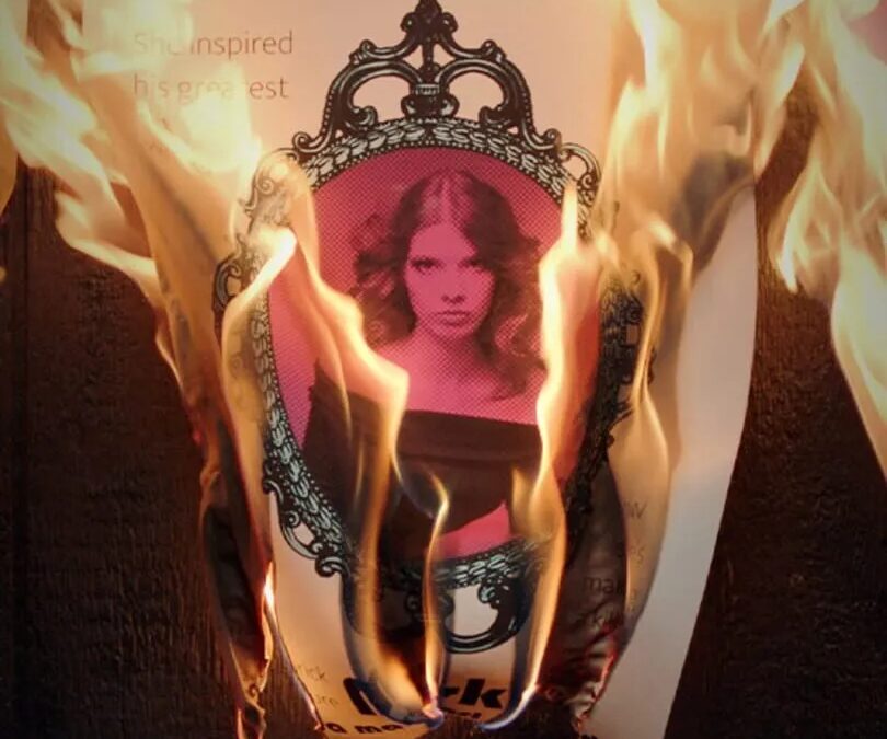 Газета с изображением иписанным вокруг рамки в огне