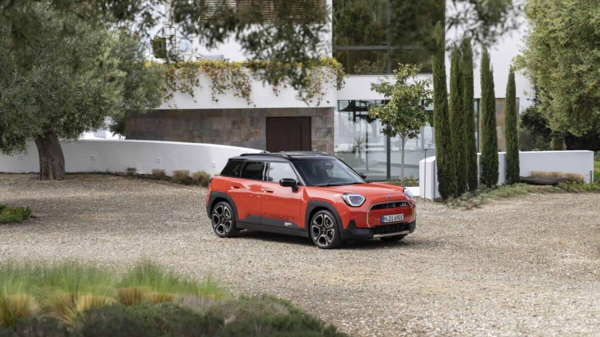 красный электромобиль MINI Aceman на грунтовой дороге