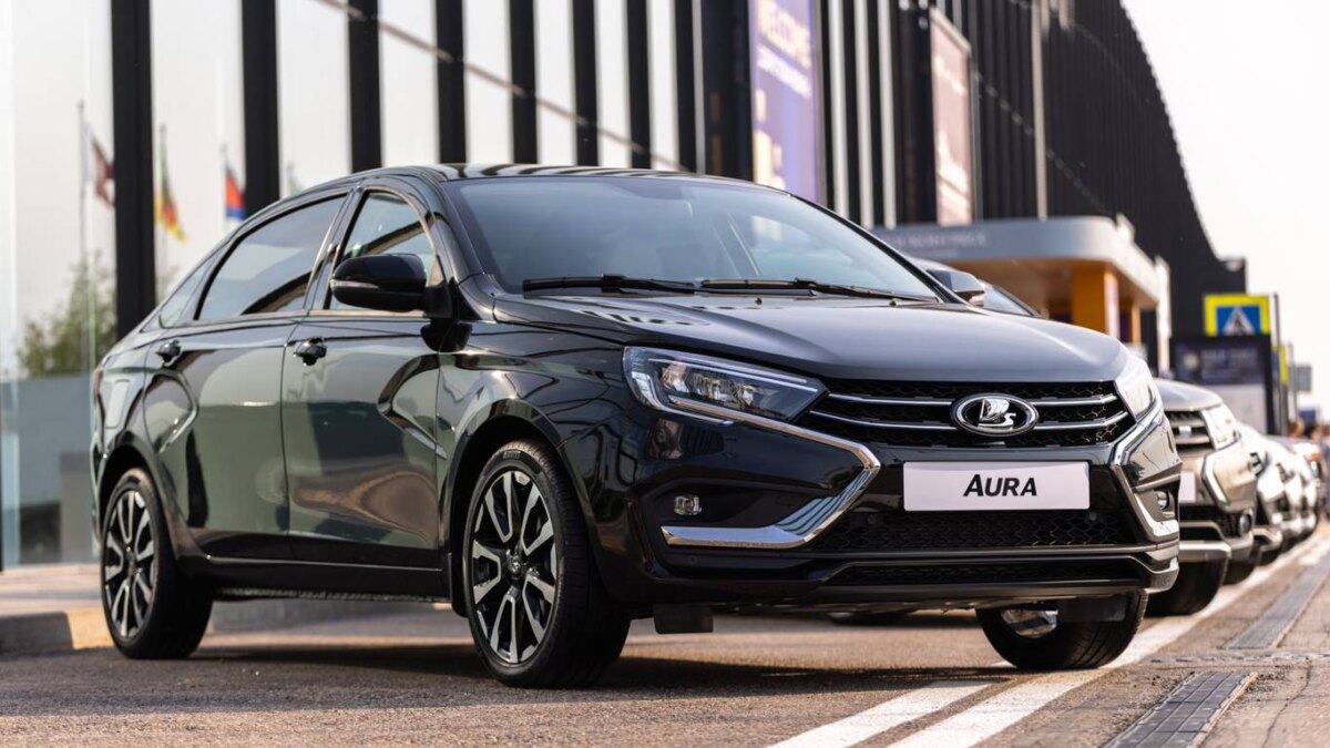 Черная Lada Aura на улице, вид спереди и сбоку, современный автомобиль на дороге