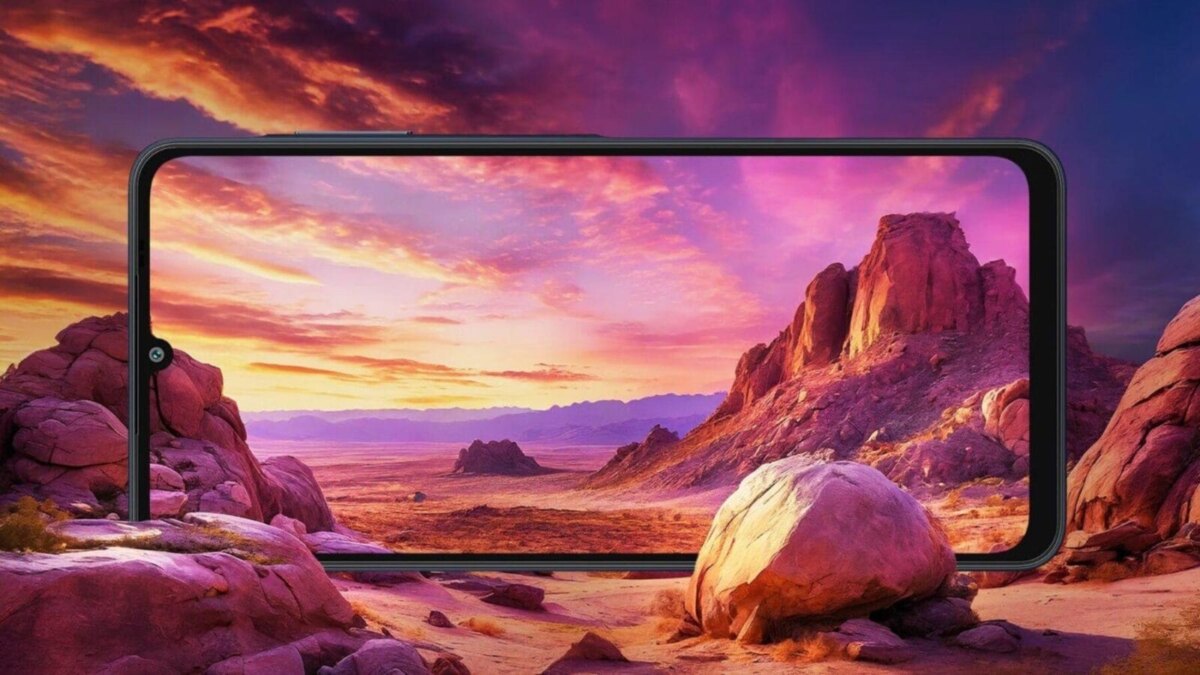 Экран смартфона Samsung Galaxy A06 показывает пейзаж с горами и закатом