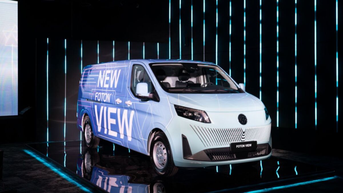 Фургон FOTON VIEW на выставочной платформе с вертикальными световыми линиями