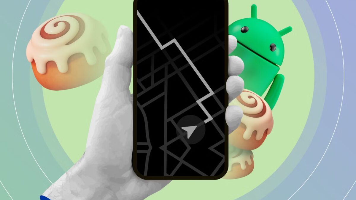 hand holding a phone showing a minimalist map on the always on display with the android mascot and cinnamon rolls in the background
