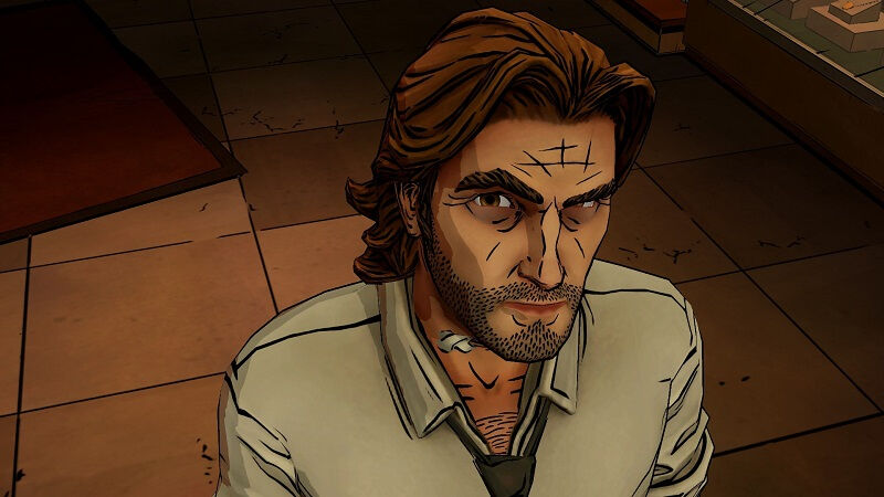 Мужчина с длинными темными волосами и бородой в помещении для анонса The Wolf Among Us 2