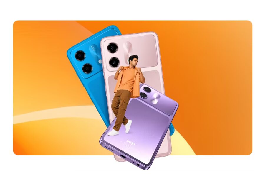Молодой человек стоит возле больших изображений смартфонов HMD Vibe 2 5G