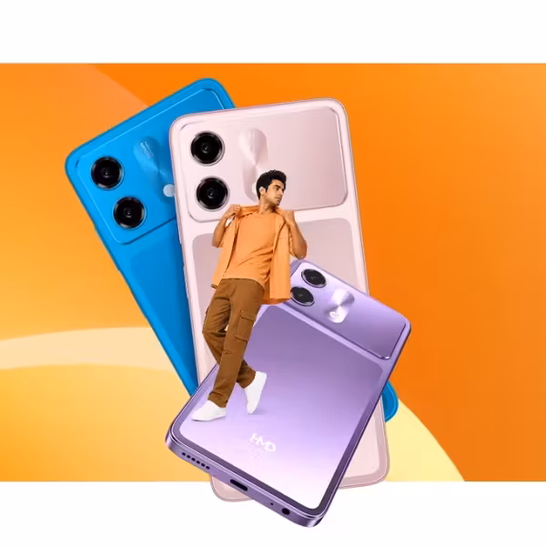 Молодой человек стоит возле больших изображений смартфонов HMD Vibe 2 5G