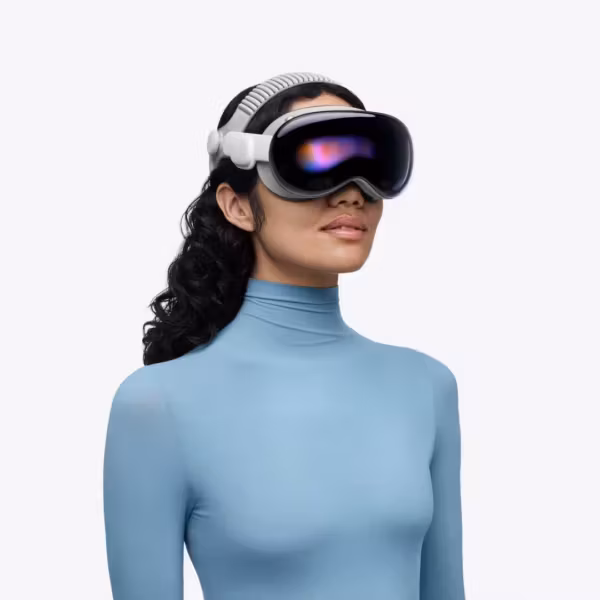 Женщина в голубом жакете с VR очками Apple Vision Pro